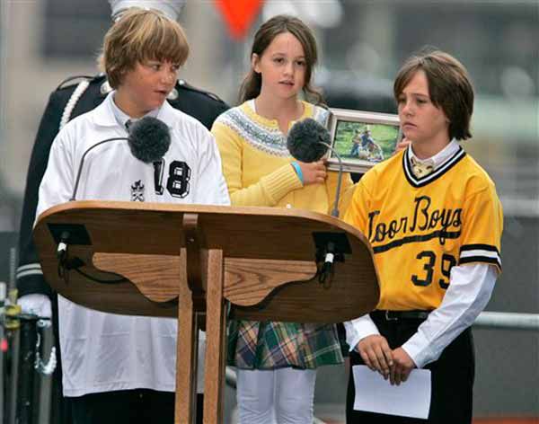 Alex Salamone, left, speaks as his brother, Aiden Salamone, right, and sister, Anna, center, looks on. Their father John Salamone died during the Sept. 11th attacks.